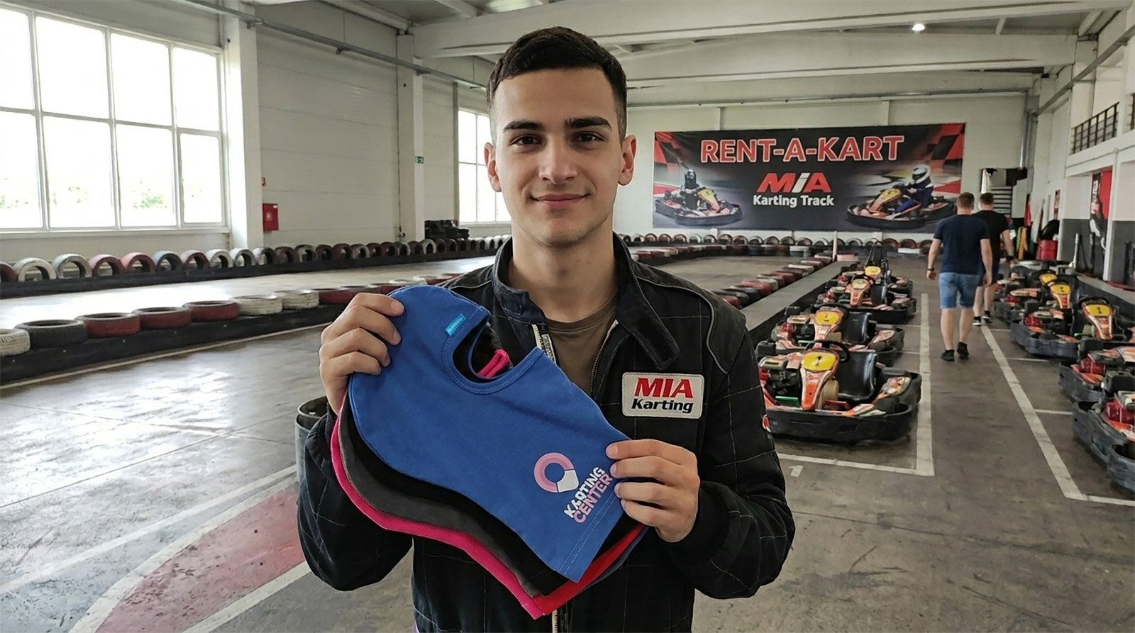 A track employee showcasing Humboo's certified balaclavas – safety balaclavas and professional B2B accessories for rental shops and tracks.